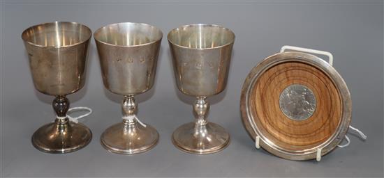 Three silver goblets by Mappin & Webb and a Merchant Taylors Company bottle coaster, 17oz (weighable)